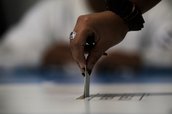 A woman casts her vote during the presidential election, in Guatemala City